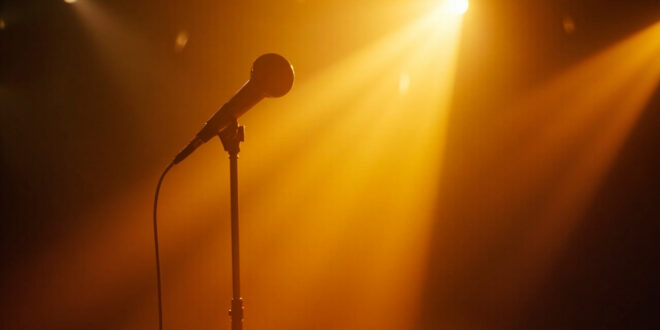 Vintage microphone on empty stand bathed in golden light within a quiet recording studio, symbolizing absence and resilience