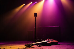Vintage microphone stand on empty stage with lone electric guitar resting against amplifier in abandoned concert venue