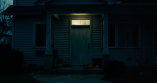 Closed front door of suburban house with children's toys scattered on front porch steps.