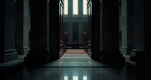 Closed ornate wooden doors of government building with brass handles and marble surroundings