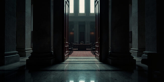 Closed ornate wooden doors of government building with brass handles and marble surroundings