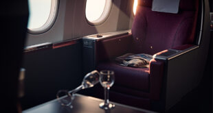 Abandoned first class cabin with empty luxury seat, overturned champagne glass on tray table amid aircraft disruption