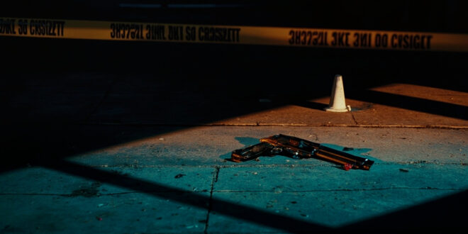 Empty urban street with police evidence markers and yellow tape cordoning off investigation area