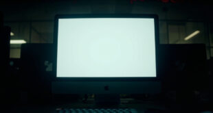 Empty computer screen showing deleted social media post notification in university office setting