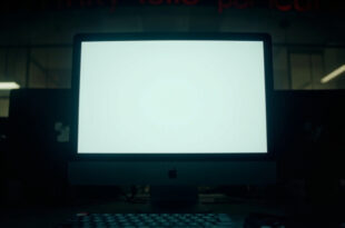 Empty computer screen showing deleted social media post notification in university office setting