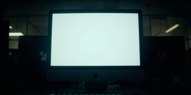 Empty computer screen showing deleted social media post notification in university office setting