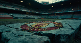 Weathered Manchester United crest embedded in cracked concrete stadium foundation under overcast sky