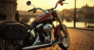 Chrome Harley Davidson motorcycle with red and black flannel shirt draped over seat, Prague cityscape background
