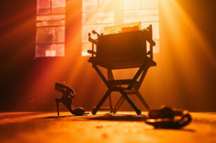 Empty director's chair with final script in abandoned film studio at golden hour, vintage typewriter nearby, high heels on floor