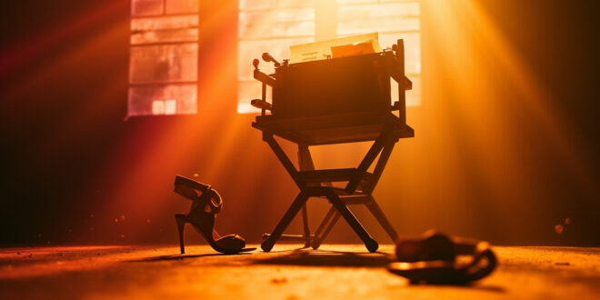 Empty director's chair with final script in abandoned film studio at golden hour, vintage typewriter nearby, high heels on floor