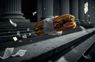 A submarine sandwich suspended in air above scattered legal documents near courthouse columns.