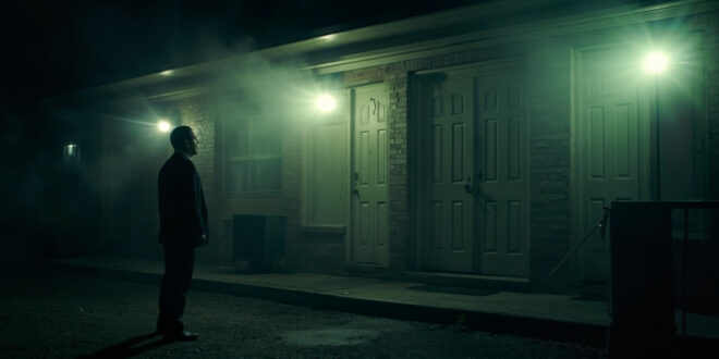 Solemn funeral home exterior at dawn with closed hearse doors during a crime investigation