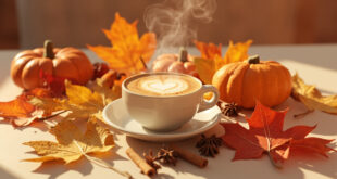 Coffee cup with heart foam on wooden counter surrounded by autumn pumpkins and cinnamon sticks
