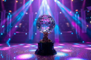 Glittering mirrorball trophy on dance floor under dramatic purple stage lighting with scattered sparkles