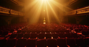Empty ornate theater with vacant honorary seats and a golden trophy on pedestal in an abandoned concert hall