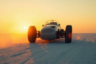 Abandoned racing vehicle on Bonneville Salt Flats at dusk, with solitary tracks stretching across the stark white desert
