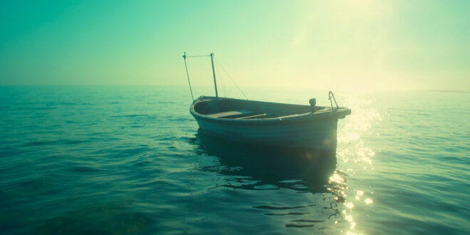 Abandoned motorboat drifting in shallow turquoise waters of New Jersey bay during afternoon light