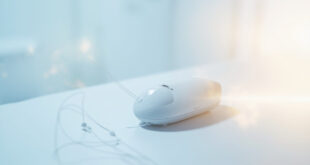 Medical therapy device with cables on clean surface, surrounded by soft blue and amber lighting.