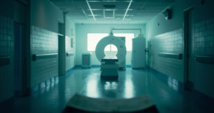 Empty hospital corridor with abandoned medical chart on examination table and MRI scanner in sterile examination room