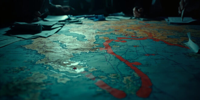 Strategic maps with territorial boundary markers and crossed-out buffer zone proposals on dark war room table surface