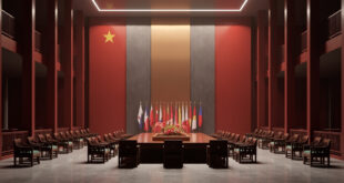 Empty diplomatic meeting room with ornate Chinese table, multiple national flags, and formal ceremonial chairs