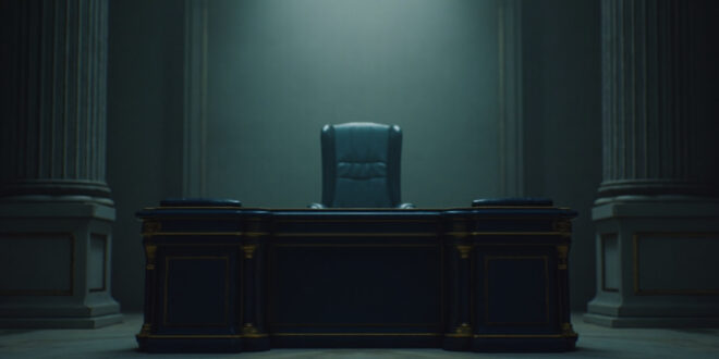 Empty ornate government office with leather chair and wooden desk in classical French interior