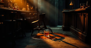 Dimly lit bar interior showing overturned stools and spilled drinks on polished counter