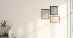 Elegant empty frames arranged on wall in modern home with sophisticated decor and warm lighting