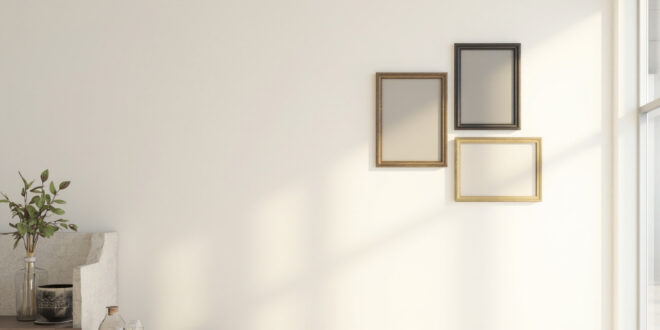 Elegant empty frames arranged on wall in modern home with sophisticated decor and warm lighting