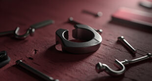 Two broken wedding rings separated on aged wood surface with scattered rose petals and torn papers.