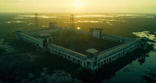 Aerial view of empty detention facility with concrete buildings surrounded by Everglades wetlands and security fencing