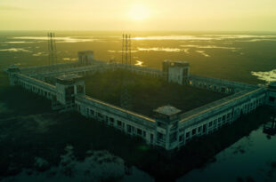 Aerial view of empty detention facility with concrete buildings surrounded by Everglades wetlands and security fencing