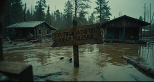 Damaged summer camp buildings with debris scattered around flooded grounds and overturned furniture