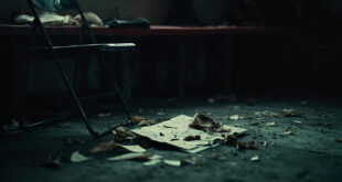 Empty dugout chair with scattered tactical notes and clipboard on concrete floor of football stadium