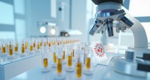 Laboratory microscope and test tubes containing amber samples on sterile white surface with clinical lighting