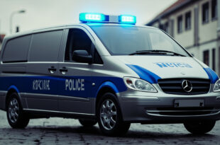 Silver Mercedes van with blue LED light bar on roof being loaded onto tow truck by authorities