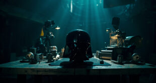Dark helmet prop and vintage film equipment arranged on movie studio table under dramatic lighting