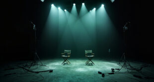 Two separated director chairs on dark television studio set with broken lighting equipment and tangled cables