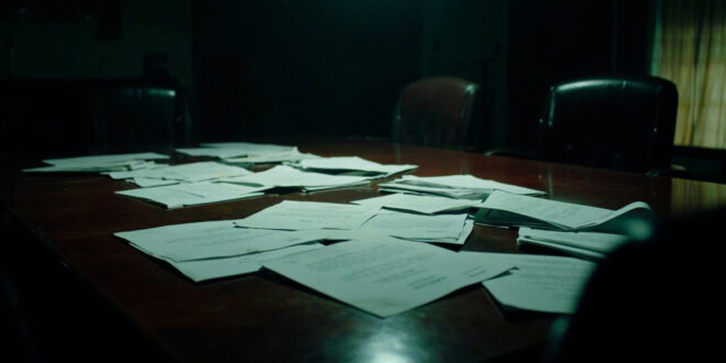 Empty boardroom table with scattered official documents and vacant leather chairs in dramatic lighting