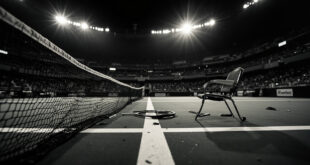 Empty professional tennis court with net, lines, and abandoned rackets under stadium lighting