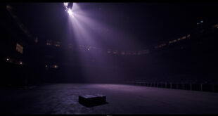 Empty concert stage with dramatic lighting in darkened stadium venue, abandoned briefcase visible on floor