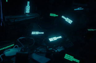 Dark room with glowing smartphone screens showing blocked numbers and message notifications on bed