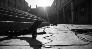 Black tactical gear including helmet and vest abandoned on concrete steps of empty university campus building