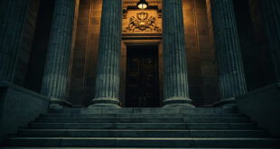 Federal courthouse building with imposing columns and carved justice scales on stone facade