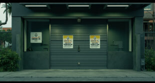 Closed storefront with metal security gates in tropical commercial area, showing an empty cannabis dispensary