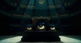 Empty military ceremony hall with draped flags and vacant podium under dramatic lighting