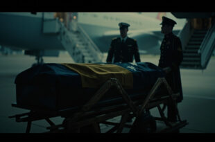 Flag-draped mahogany coffin beside government aircraft on airport tarmac under dramatic lighting