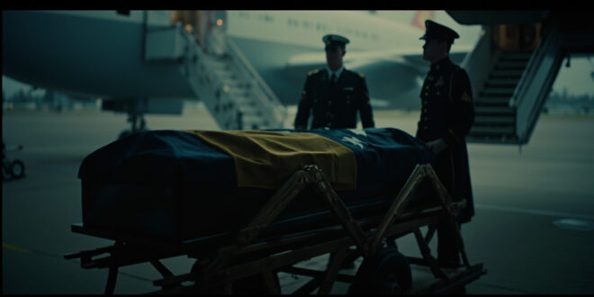 Flag-draped mahogany coffin beside government aircraft on airport tarmac under dramatic lighting