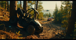 Overturned ATV wreckage against tree trunk on mountain trail with emergency vehicles nearby