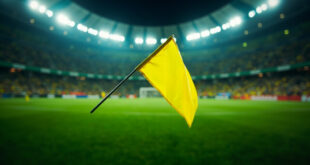 Yellow penalty flag thrown on football field at Arena Corinthians stadium in Brazil